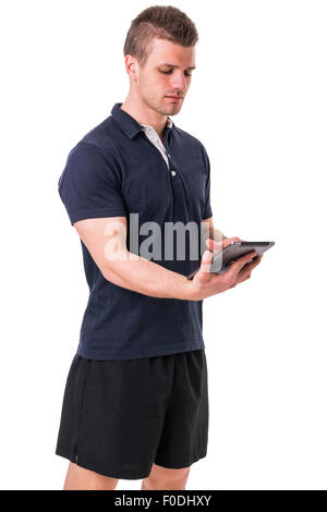 Handsome young personal trainer with tablet PC, standing isolated on white background Stock Photo