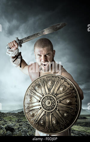Gladiator posing with shield and sword ready to fight Stock Photo - Alamy
