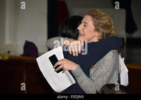 A teenage girl hugging her friend and looking pleased with her GCE exam results at a London Secondary School England UK Stock Photo