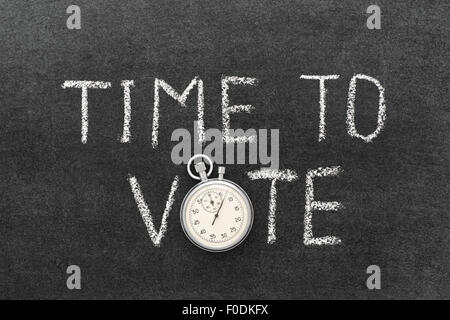 time to vote phrase handwritten on chalkboard with vintage precise stopwatch used instead of O Stock Photo