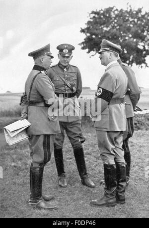Hitler, Adolf, 20.4.1889 - 30.4.1945, German politician (NSDAP), Chancellor of the Reich 30.1.1933 - 30.4.1945, with Minister of War Werner von Blomberg (centre and commander-in-chief of the army general Werner von Fritsch (left), military training area Munster, 1935, Stock Photo