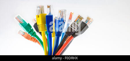 Colorful Ethernet patch cords with RJ-45 connectors in a bunch on the white background Stock Photo