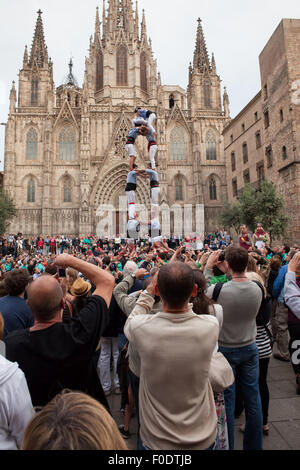 People crowd watching Castell human tower at Barcelona Cathedral in Catalonia, Spain Stock Photo