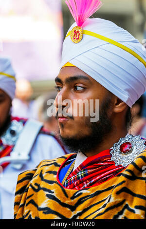 Glasgow, UK, 13th Aug, 2015. At Glasgow's annual Festival of Bagpipe music, 'Piping Live', which ends with the World Championship competition on Saturday 15the August, the National Pipe Band of Malaysia - 'The Sri Dasmesh Pipe Band' based in Kuala Lumpar, entertained the crowds in Buchanan Street and George Square, by playing a medley of Scottish bagpipe music on a sunny day in Scotland. Credit:  Findlay/Alamy Live News Stock Photo