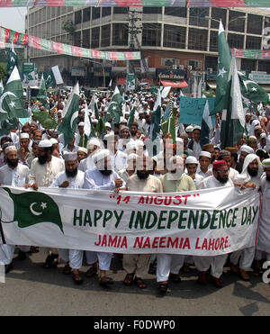 Lahore. 13th Aug, 2015. Pakistani people march on a street on the eve of the country's Independence Day celebrations in eastern Pakistan's Lahore on Aug. 13, 2015. Pakistan will celebrate its 68th anniversary on Aug. 14. Credit:  Sajjad/Xinhua/Alamy Live News Stock Photo