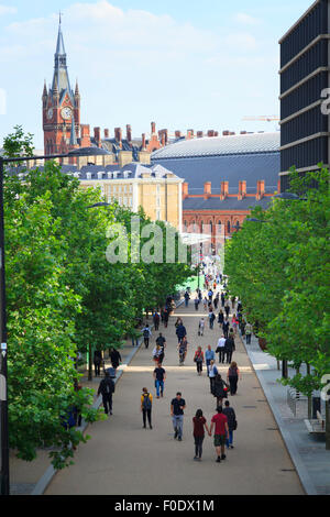 People walking along King's Boulevard with the St Pancras Clock Tower