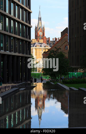 Clock Tower of St Pancras Station reflected in the steped water feature of St Pancras Square Stock Photo