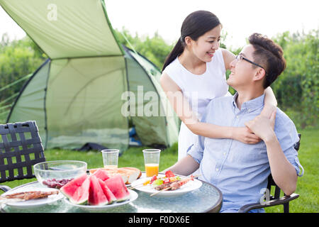Young couple picnicking outdoors Stock Photo