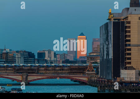 View from Waterloo Bridge looking towards Canary Wharf  and Blackfriars Bridge as the late afternoon sunlight reflects from One Canada Square , London Stock Photo