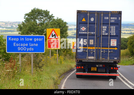 lorry passing emergency escape lane warning sign in case of brake failure on steep hill at staxton scarborough yorkshire uk Stock Photo