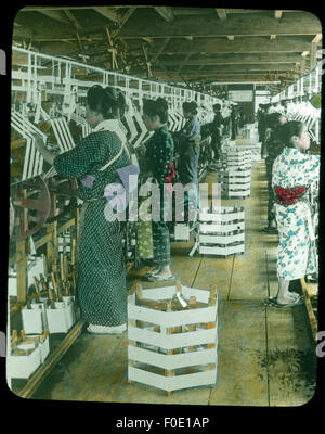 This image depicts the process of reeling silk into small skeins, a crucial step in silk production. The careful handling and processing of silk are vital for maintaining quality. Stock Photo