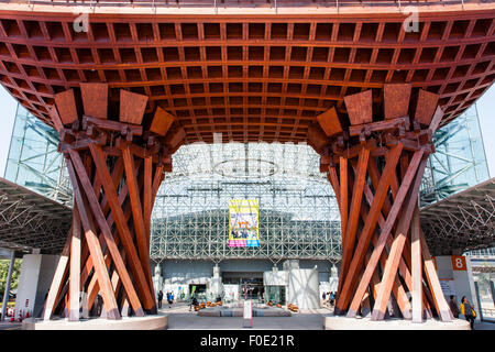Japan, Kanazawa station. The orange Tsuzumi-mon, drum shaped gate outside the atrium, Motenashi (Welcome) glass framed Dome. Blue sky. Stock Photo