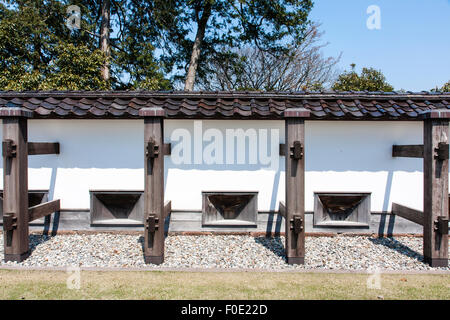 Japan, Kanazawa. Castle. Reconstructed Dobei wood, mud and white plaster roofed wall with supporting buttresses and firing slots called sama. Stock Photo
