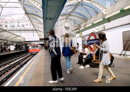 People on the paltform getting the tube, Hammersmith London Underground Station, Hammersmith, London UK Stock Photo