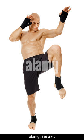 Muay thai fighter delivering a knee blow, isolated on white background Stock Photo