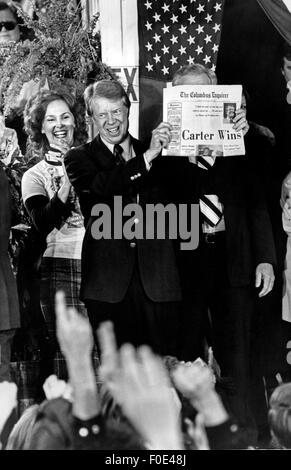 Jan. 11, 2015 - President Elect Jimmy Carter holds up a newspaper declaring ''Carter Wins'' as its' headline the morning after the 1976 General Election. Carter, fariends, family and supporters jammed the streets around the railway depot in Carter's hometown of Plains, Ga. (Credit Image: © Ken Hawkins via ZUMA Wire) Stock Photo