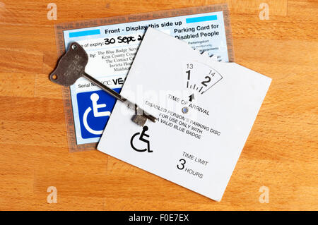 A disabled person's parking disc & blue card to allow use of disabled parking spaces and Radar key to open disabled toilets. Stock Photo