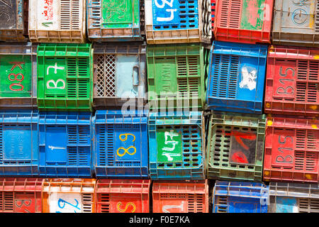 Colorful boxes plastic crates. Packing containers piles for fish storage of catch. Morocco Stock Photo