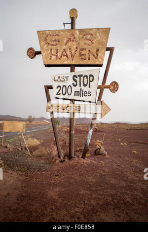 Tall vintage and abandoned gas sign standing along the deserted road to Ouarzazatein in Morocco. Stock Photo