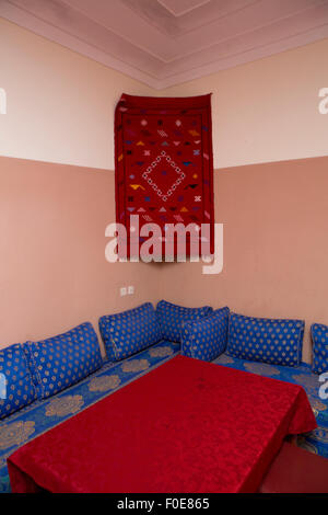Colorful fabrics and traditional furnitures in classical Moroccan Interior. Stock Photo