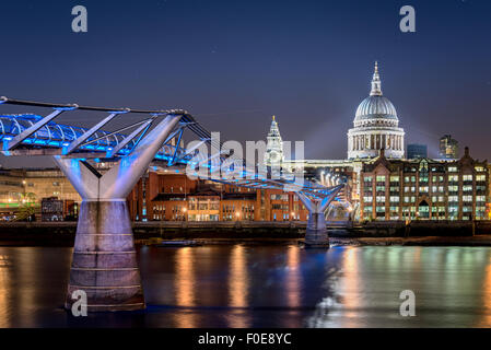 Millennium bridge over river Thames and St Pauls cathedral are among the famous landmarks of London England. Stock Photo