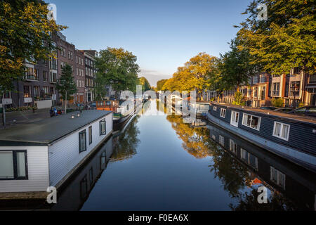 Row of boat house on both side of canal in Amsterdam Netherlands. Stock Photo