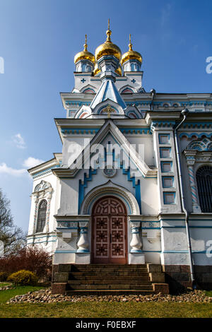 Front view of Orthodox Ss Boris and Gleb Cathedral in Dougavpils, Latvia, on blue cloudy sky background. Stock Photo