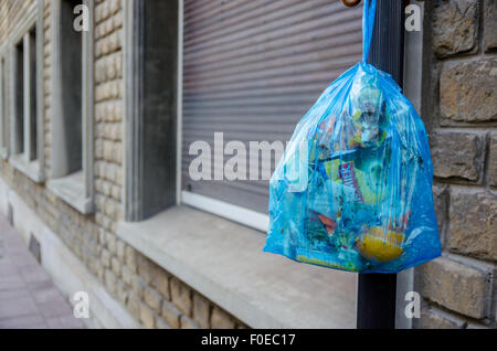 garbage bag for plastic hanging in the street for pick up garbage  collector, waiting to destroy. Recycle and environment concept Stock Photo  - Alamy