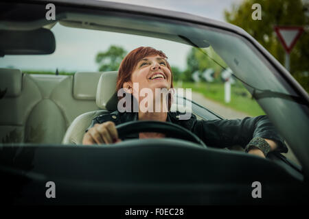 Woman enjoying driving her convertible car Stock Photo