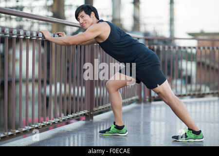 Young man exercising outdoors Stock Photo