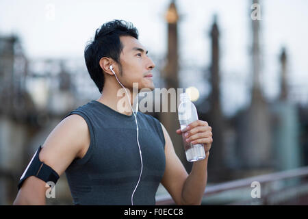Young man having a rest after exercising outdoors Stock Photo
