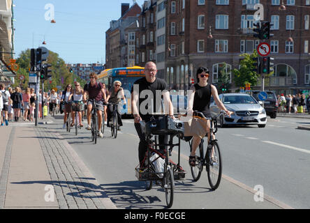 Cyclists towards the centre of Copenhagen on Torvegade at Christianshavn's Torv, Christianshavn Square, and further on bridge to central Copenhagen.