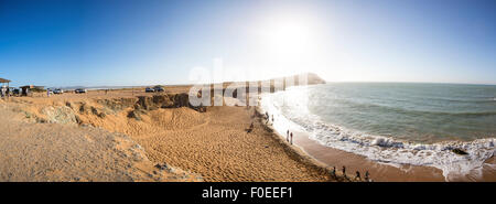 Panorama of Unidentified people having fun at a wild coastal beach of Penisula la Guajira near the Cabo de la Vela Stock Photo