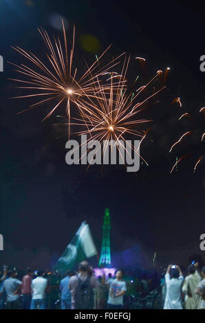 Lahore, Pakistan. 13th Aug, 2015. A splendid view of the fire works by the Pakistan Horticulture Authority (PHA) on the eve of Independence Day in Lahore. The annual celebration is every 14th day of August, since the country gained its independence from the British rule on August 14, 1947. The celebration consist of fire works and people parade dress-up in green and white, which represents Pakistans' official flag colors. Credit:  Rana Sajid Hussain/Pacific Press/Alamy Live News Stock Photo
