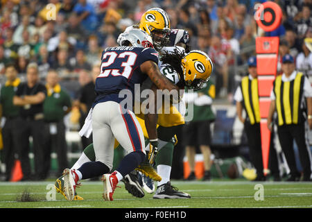 Foxborough, Massachusetts, USA. 13th August, 2015. Green Bay Packers running back Eddie Lacy (27) is wrapped up by New England Patriots strong safety Patrick Chung (23) during an NFL pre-season game between the Green Bay Packers and the New England Patriots held at Gillette Stadium in Foxborough Massachusetts. The Packers defeated the Patriots 22-11 in regulation time. Eric Canha/CSM/Alamy Live News Stock Photo