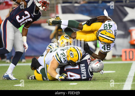 Foxborough, Massachusetts, USA. 13th August, 2015. New England Patriots wide receiver Chris Harper (14) is brought down by Green Bay Packers fullback Aaron Ripkowski (22) and linebacker Joe Thomas (48) during an NFL pre-season game between the Green Bay Packers and the New England Patriots held at Gillette Stadium in Foxborough Massachusetts. The Packers defeated the Patriots 22-11 in regulation time. Eric Canha/CSM/Alamy Live News Stock Photo
