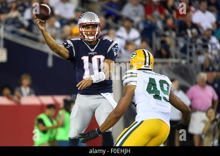 Foxborough, Massachusetts, USA. 13th August, 2015. New England Patriots quarterback Jimmy Garoppolo (10) throws a pass under pressure from Green Bay Packers outside linebacker Adrian Hubbard (49) during an NFL pre-season game between the Green Bay Packers and the New England Patriots held at Gillette Stadium in Foxborough Massachusetts. The Packers defeated the Patriots 22-11 in regulation time. Eric Canha/CSM/Alamy Live News Stock Photo