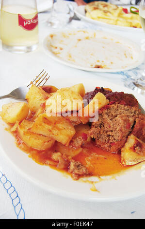 Greek meatballs and potatoes at a taverna in Loutro Crete Stock Photo