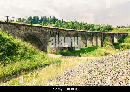 Old railway bridge viaduct in the Carpathians Stock Photo