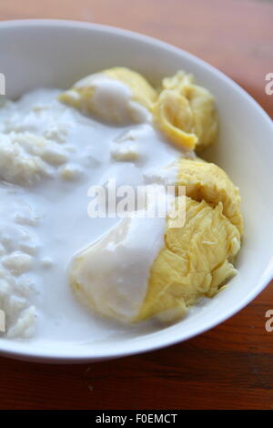 Durian Flesh eaten with coconut milk and white glutinous rice Stock Photo