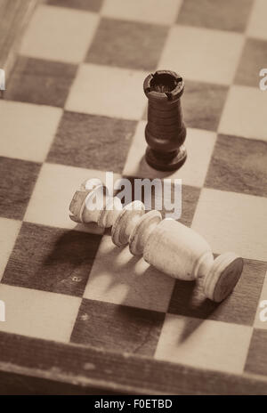 Close up of chess board with two pieces. The king is defeated and the game is lost. Stock Photo