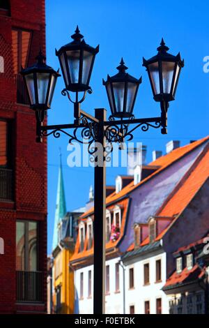 Latvia. High street light on the background of the facades and roofs of the old city of Riga on a sunny summer day Stock Photo
