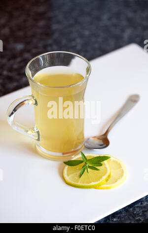 Lemon green tea in a glass mug.