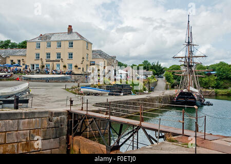 Charlestown historic harbour, Cornwall, with the square-rigged sailing ship 'Phoenix of Dell Quay' berthed in the dock Stock Photo