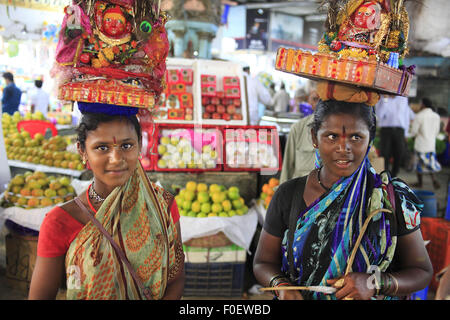 Mumbai, Maharashtra. 2nd Apr, 2014. 02 April 2014, Mumbai - India.A girl asks for donations in lieu of blessings from the Hindu Goddess from visitors at the Crawford Market.Crawford Market is the largest in Mumbai, and contains the last whiff of British Bombay.The Crawford Market houses a wholesale fruit, vegetable and poultry market. One end of the market is a pet store. Different varieties of dogs, cats, and birds can be found in this area. Most of the sellers inside the market sell imported items such as foods, cosmetics, household and gift items. It was the main wholesale market for f Stock Photo