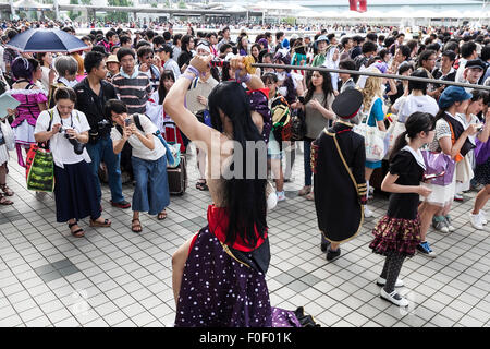 Tokyo, Japan. 14th August, 2015. Photographers line up to take pictures of a cosplayer during the ''Comic Market 88 Summer 2015'' exhibition at Tokyo Big Sight on August 14, 2015, Tokyo, Japan. Thousands of manga and anime fans attended the first day of the Comic Market 88 (Comiket) at Tokyo Big Sight. The Comic Market was established in 1975 to allow fans and artists to interact and focuses on manga, anime, gaming and cosplay. The exhibition is held from August 14th to 16th and Comiket organisers expect more than 500,000 visitors to attend. Credit:  Rodrigo Reyes Marin/AFLO/Alamy Live News Stock Photo