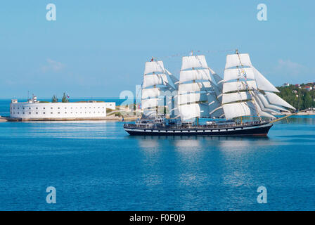 Sailing ship entering to the bay. Stock Photo