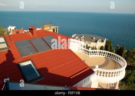 Alternative energy- solar system on the house roof. Stock Photo