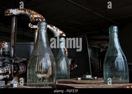Bottles still sit on the conveyor in the now closed and derelict White Star Brewery, Rick Steenweg in Belgium Stock Photo