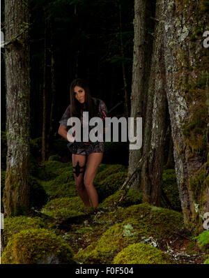 An American Indian woman hunting in a forest. Stock Photo